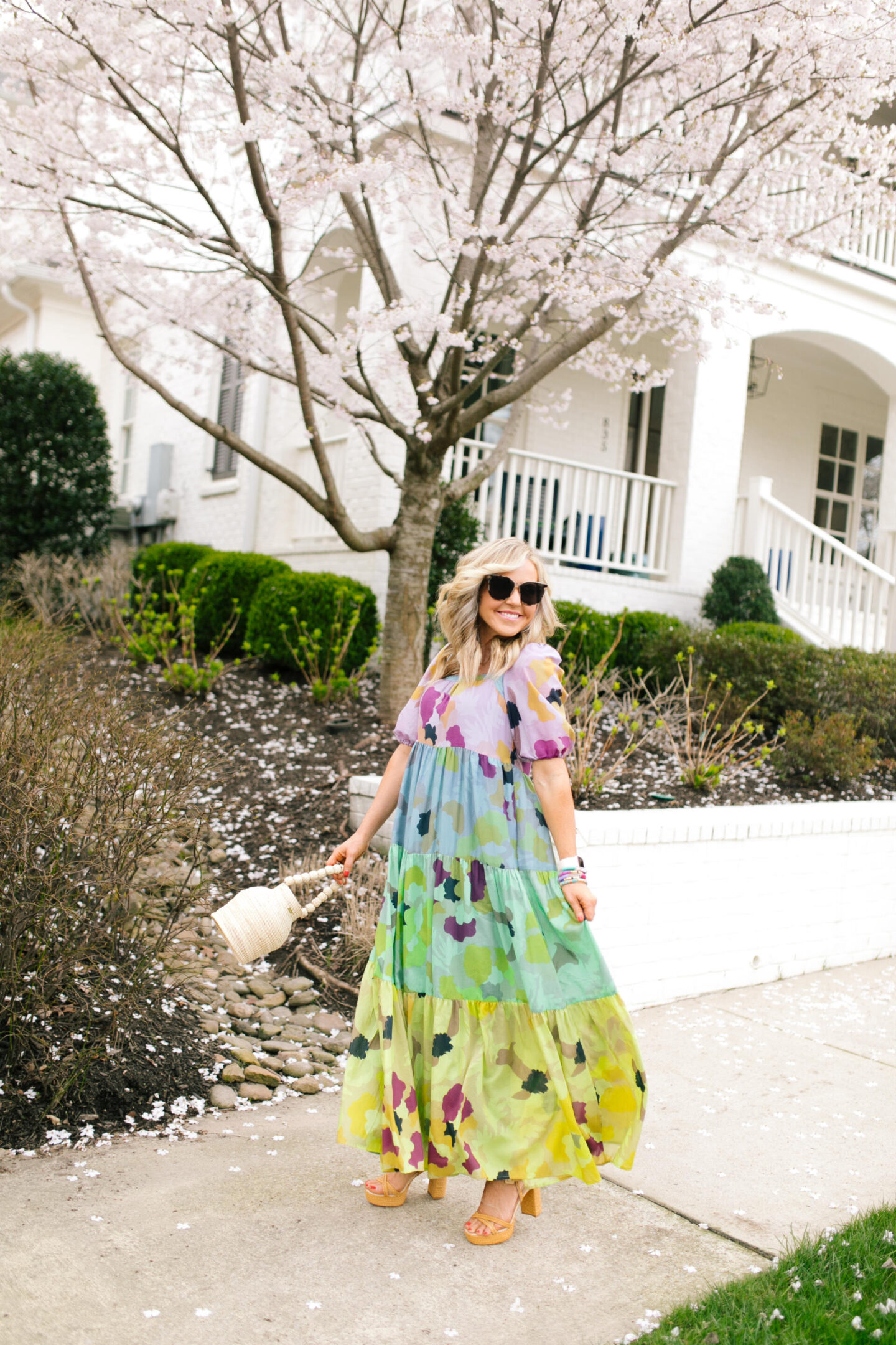 Purple Clothing by popular Nashville fashion blog, Hello Happiness: image of a woman wearing a Caroline Tiered midi, Raye Platforms, and holding a bucket bag. 