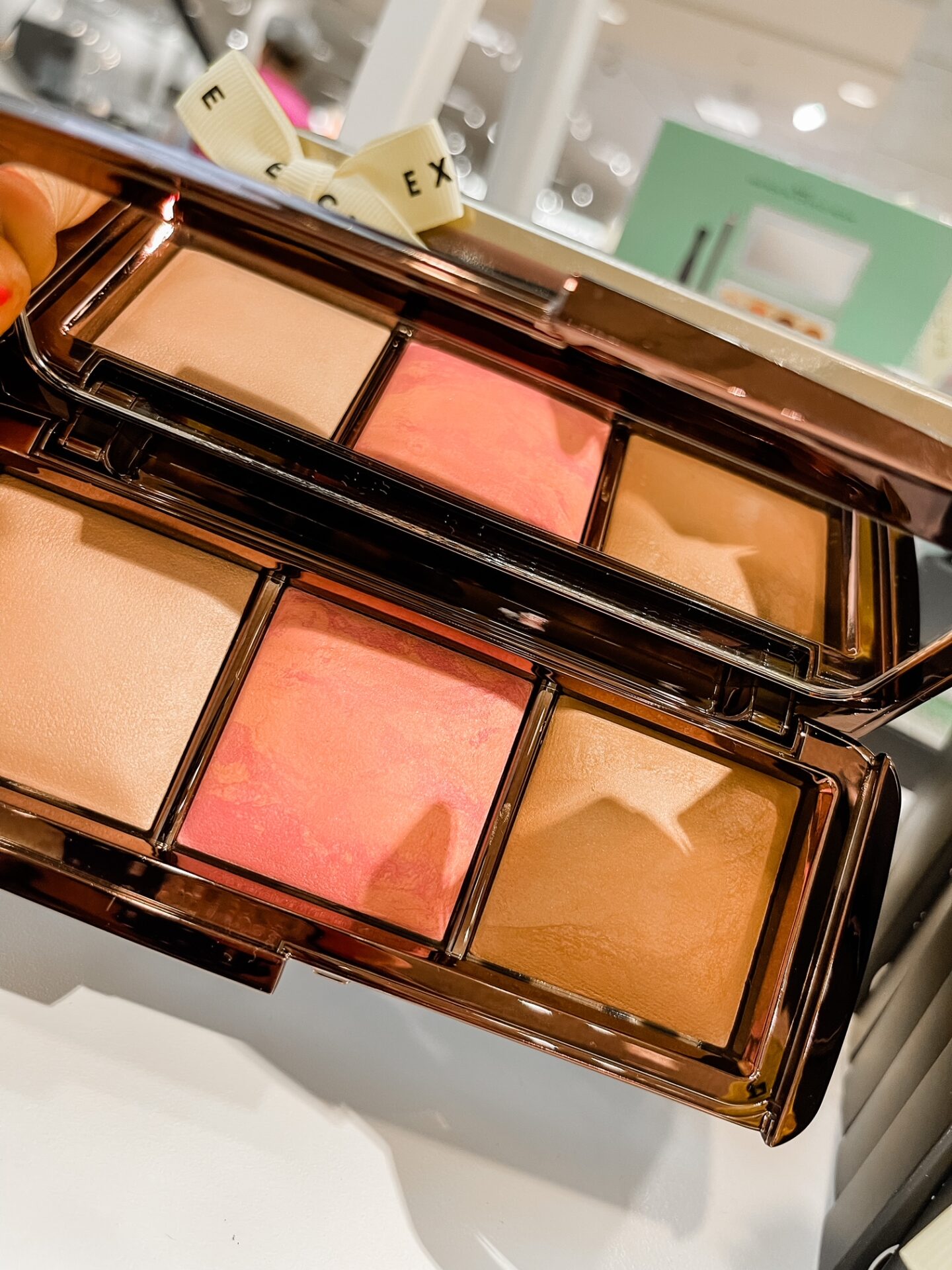 Nordstrom Anniversary Sale by popular Nashville fashion blog, Hello Happiness: image of Natasha Stoneking holding a Nordstrom hourglass ambient essentials palette.