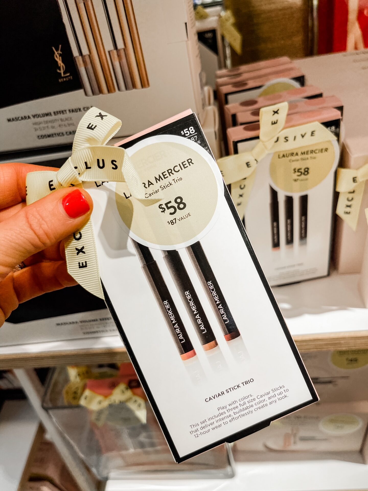 Nordstrom Anniversary Sale by popular Nashville fashion blog, Hello Happiness: image of Natasha Stoneking holding a Nordstrom Laura Mercier caviar stick trio. 