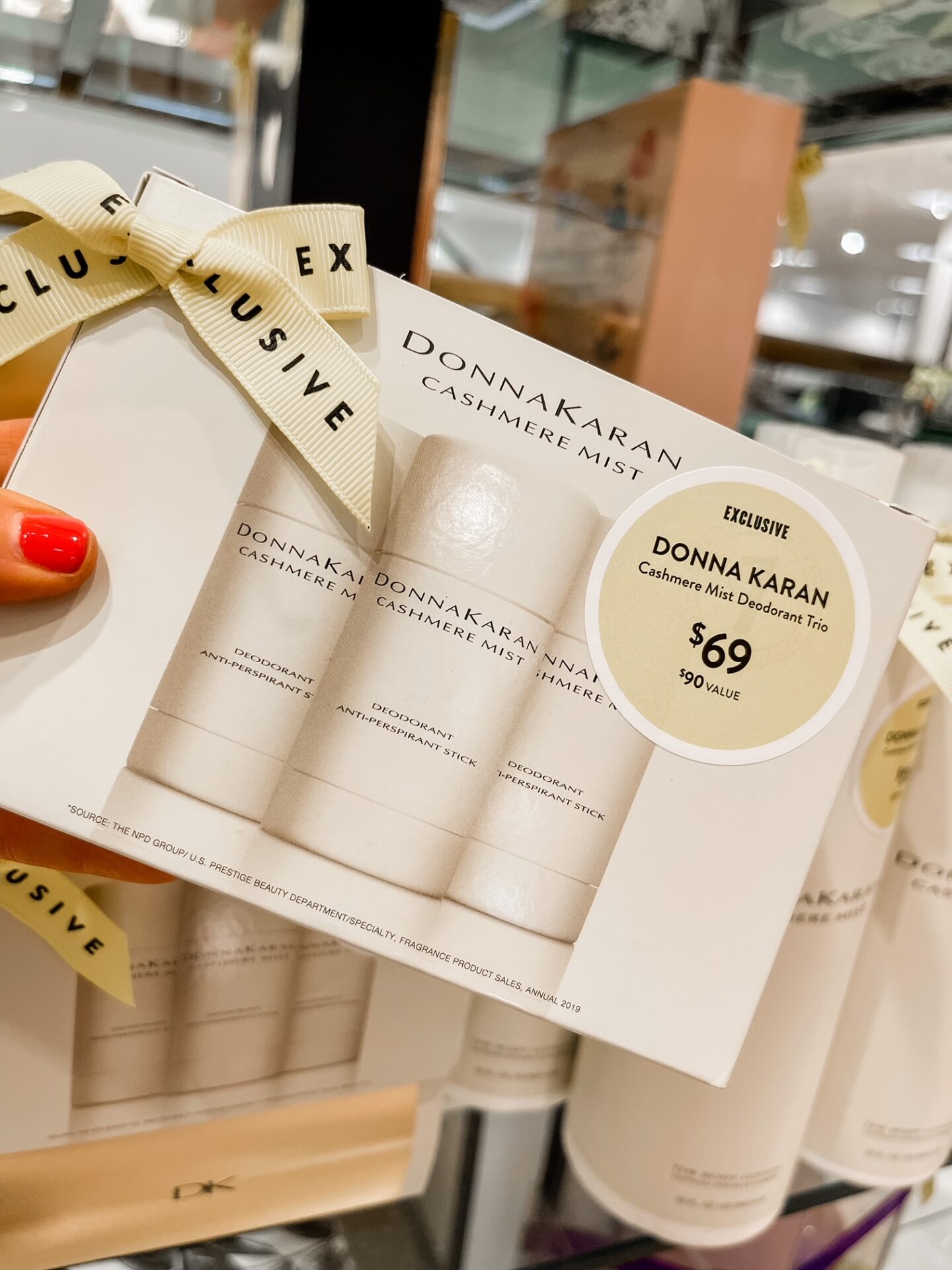 Nordstrom Anniversary Sale by popular Nashville fashion blog, Hello Happiness: image of Natasha Stoneking holding a Nordstrom Donna Karan cashmere mist deodorant trio. 