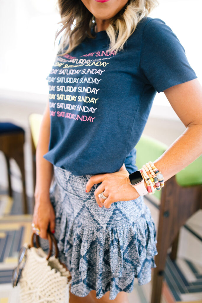 Walmart Fashion by popular Nashville fashion blog, Hello Happiness: image of a woman wearing a Walmart Weekend Graphic Tee, Walmart Ruffled Mini Skirt, Walmart Yellow Espadrilles and holding a Walmart Macrame Wooden Handle Bag.