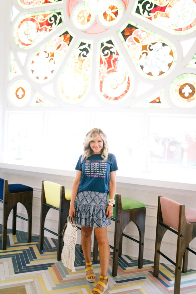 Walmart Fashion by popular Nashville fashion blog, Hello Happiness: image of a woman wearing a Walmart Weekend Graphic Tee, Walmart Ruffled Mini Skirt, Walmart Yellow Espadrilles and holding a Walmart Macrame Wooden Handle Bag.