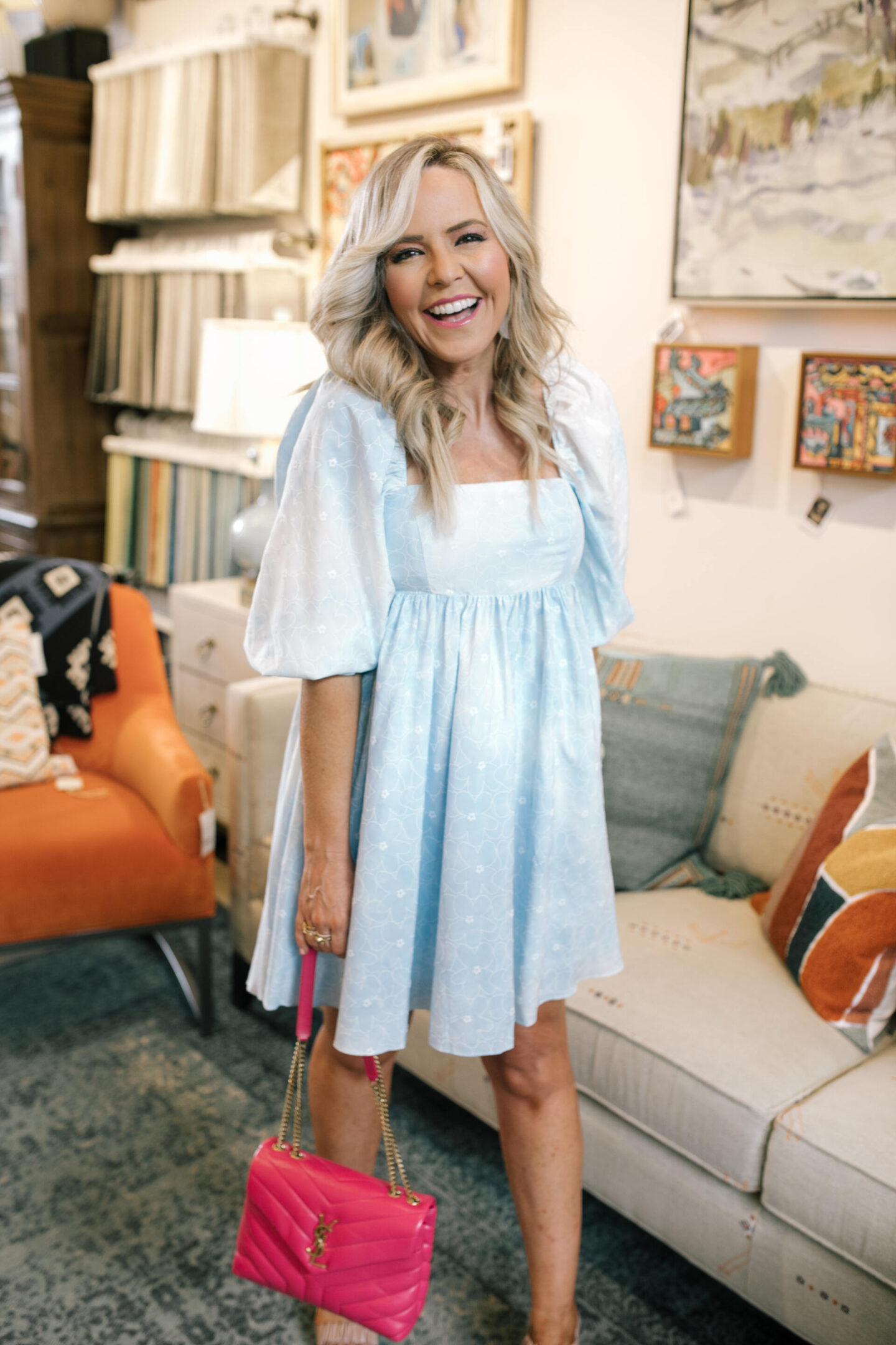 Nashville Hot Spots by popular Nashville travel blog, Hello Happiness: image of Natasha Stoneking wearing a blue eyelet babydoll dress and holding a pink YSL handbag. 