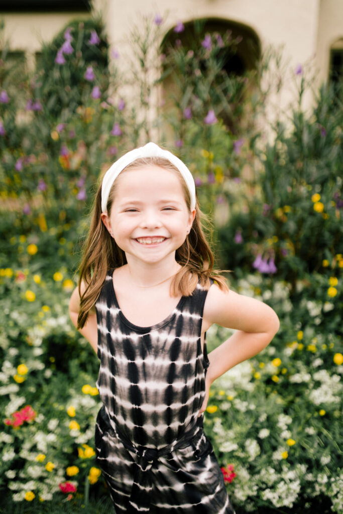 Tween Fashion by popular Nashville fashion blog, Hello Happiness: image of a girl standing outside and wearing a Target tie dye jumpsuit, gladiator sandals, and white knot headband.