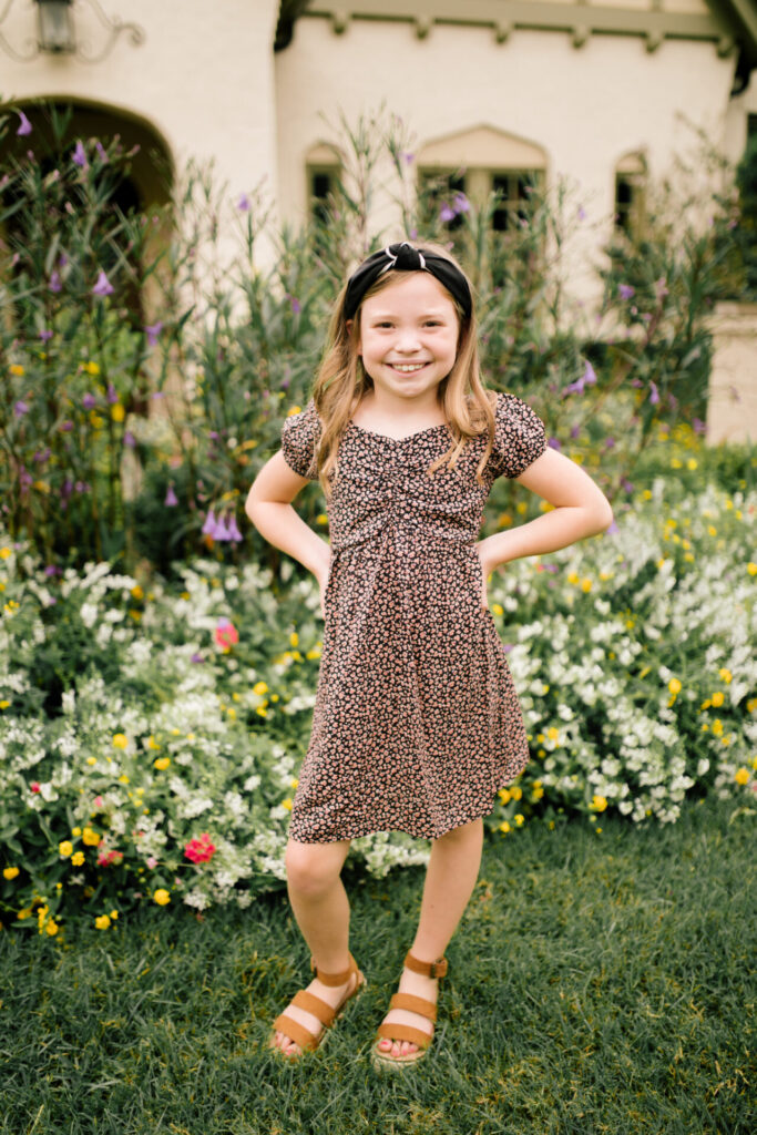 Tween Fashion by popular Nashville fashion blog, Hello Happiness: image of a girl standing outside and wearing a Target Skater ditsy print swing dress, black and white stripe knot headband, and platform espadrilles. 