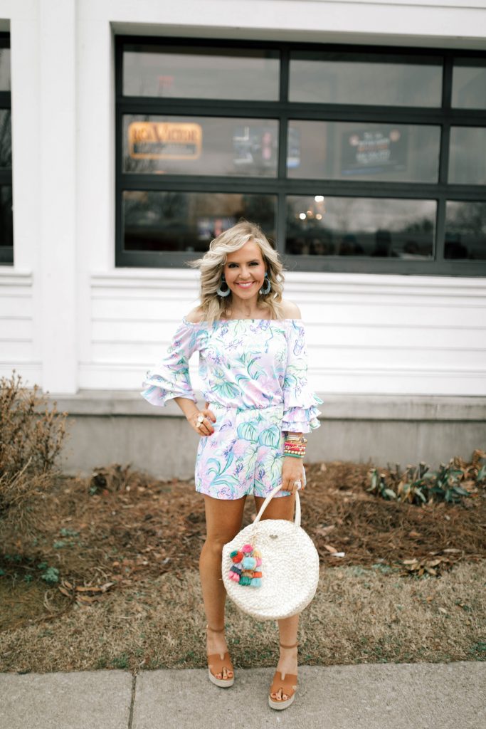 Hip Hip Hooray... The Lilly After Party Sale is Here! by popular Nashville fashion blog, Hello Happiness: image of a woman wearing a Lilly Pulitzer CALLA OFF-THE-SHOULDER ROMPER, STEVEN by Steve Madden Women's Sirena Espadrille Wedge Sandal, Amazon Straw Canteen Purse, Amazon I-BOSOM Colorful Boho Pom Pom Tassel Bag Charm Key Chain, and Nordstrom Quay Australiax JLO Limelight 54mm Oversize Sunglasses. 