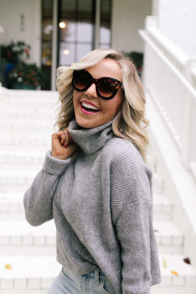 Fall Wardrobe by popular Nashville fashion blog, Hello Happiness: image of Natasha Stoneking standing on her front porch steps and wearing a Walmart Dreamers by Debut Women's Cowl Neck Sweater, Walmart Scoop Women’s Destructed Release Hem Crop Flare Jeans, Walmart Time and Tru Bit Loafer, and holding a Walmart Scoop Women's Faux Croco Top Handle Mini Crossbody Bag. 