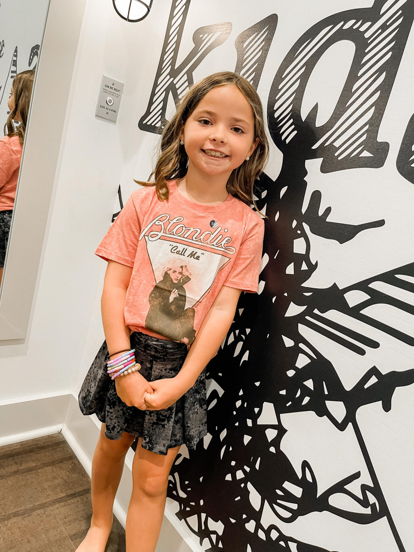 Back to School Essentials by popular Nashville lifestyle blog, Hello Happiness: image of a young girl wearing a Blondie t-shirt and black and while floral print skirt. 
