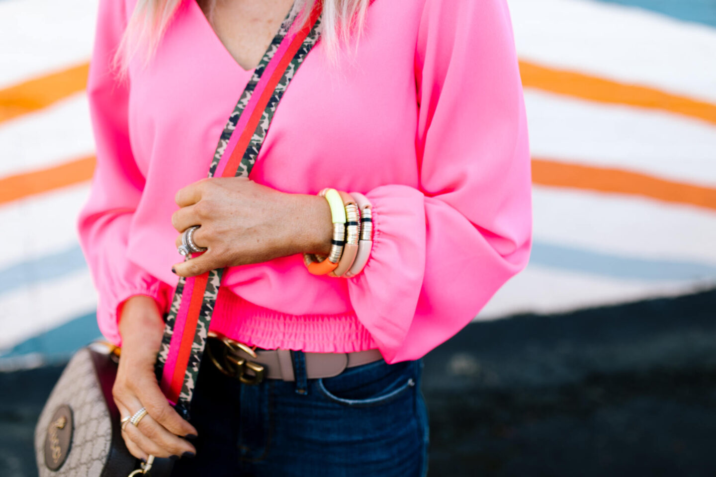 Pink Fashion by popular Nashville fashion blog, Hello Happiness: image of a woman wearing a Pink Hibiscus V-Neck Top from Sail to Sable. 