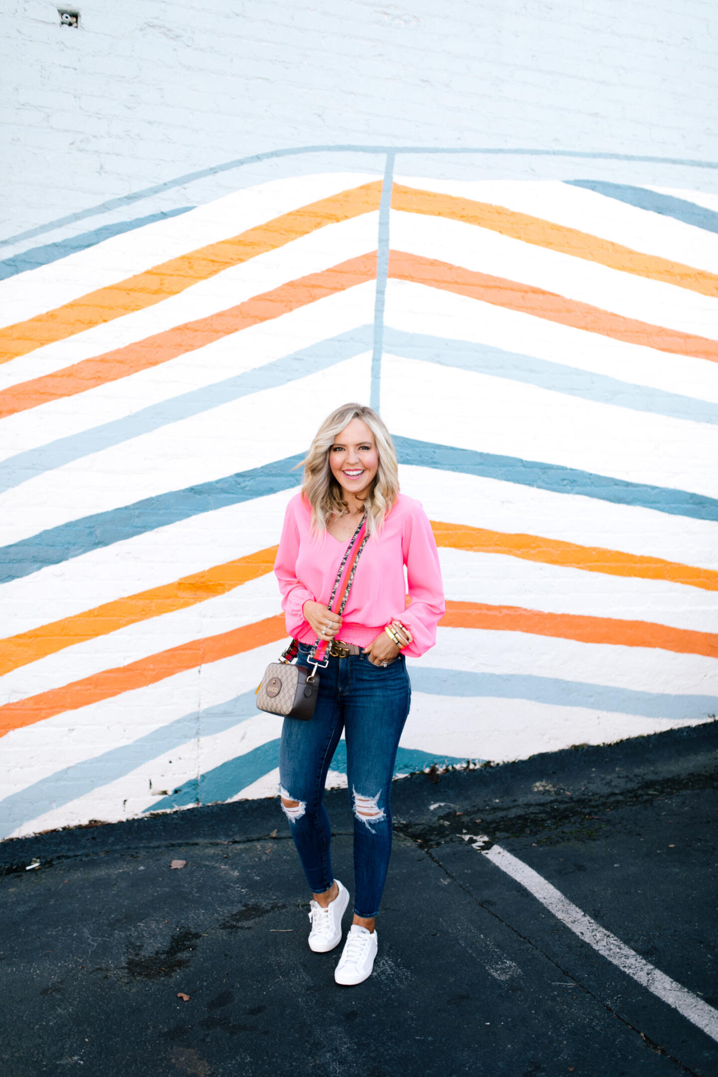 Sail to Sable by popular Nashville fashion blog, Hello Happiness: collage image of Natasha Stoneking wearing a Sail to Sable v-neck hibiscus top, Good American jeans and Gucci camera bag with a camo colorblock strap. 