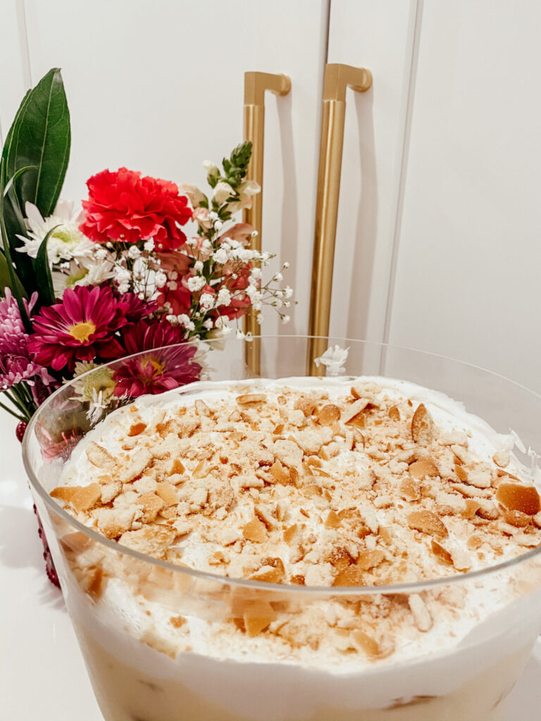 Magnolia Bakery Banana Pudding by popular Nashville lifestyle blog, Hello Happiness: image of Magnolia Bakery Banana Pudding in a Williams Sonoma Glass Trifle Bowl.
