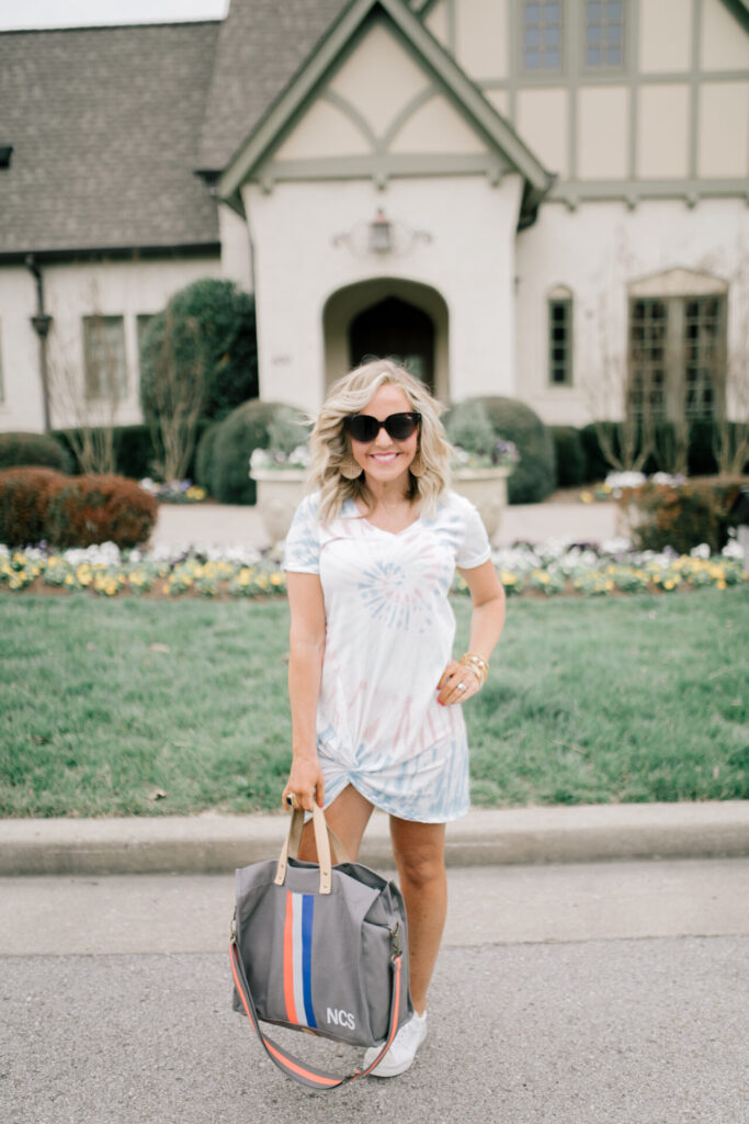 Z Supply by popular Nashville fashion blog, Hello Happiness: image of a woman wearing a Z Supply Naibi cropped jacket, tie dye side knot dress, tote-ally bag, and rezza sneakers.