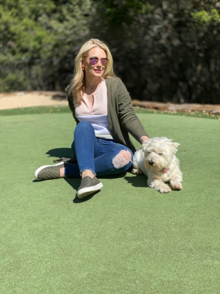 Puppy Products by popular Nashville life and style blog, Hello Happiness: image of Ms Gold Girl kneeling next to her dog. 