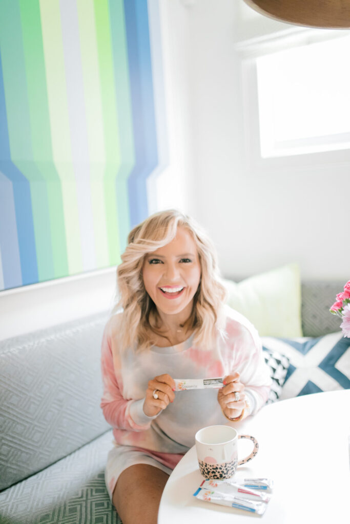Cocoavia by popular Nashville lifestyle blog, Hello Happiness: image of a woman sitting at a table with some Cocoavia stick packs.