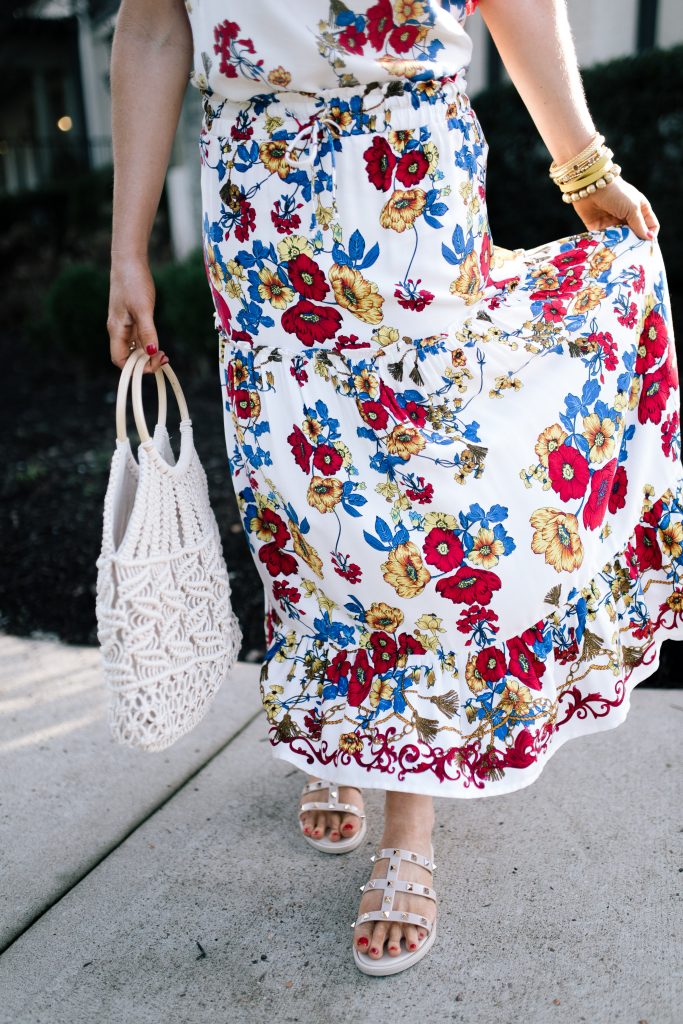 Let's Getaway... The Gibson Resort x Hi Sugarplum Collection is Here! by popular Nashville fashion blog, Hello Happiness: image of a woman wearing a Hi Sugarplum  Portofino Tiered Midi Skirt, Amazon Aphoraeny Womens Rivets Flat Sandals, Amazon boderier Beaded Drop Earrings, and ShopBop Hat Attack Cotton Cord Bag.