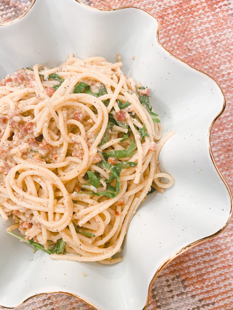 Lemon Arugula Spaghetti Cacio e Pepe by popular Nashville lifestyle blog, Hello Happiness: image of lemon arugula spaghetti cacio e pepe in a Susan Gordon Pottery Size C - Wavy Bowl.