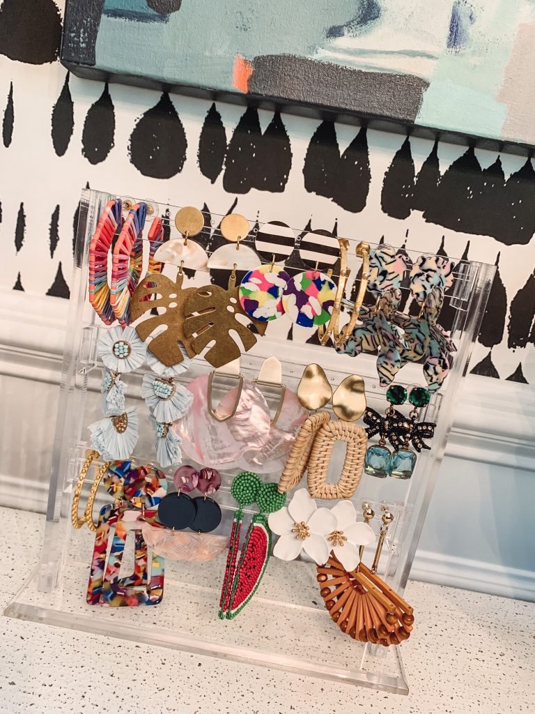 My Favorite New Amazon Find... the Ultimate Earring Organizer by popular US life and style blog, Hello Happiness: image of a Funnuf Clear Acrylic 3 Tier Jewerly Display Stand Holder Earring Organizer from Amazon with various earring hanging on it. 