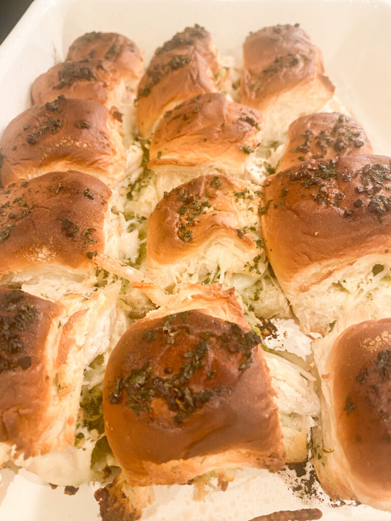 Chicken Pesto Sliders by popular Nashville lifestyle blog, Hello Happiness: image of Chicken Pesto Sliders in a white baking dish. 