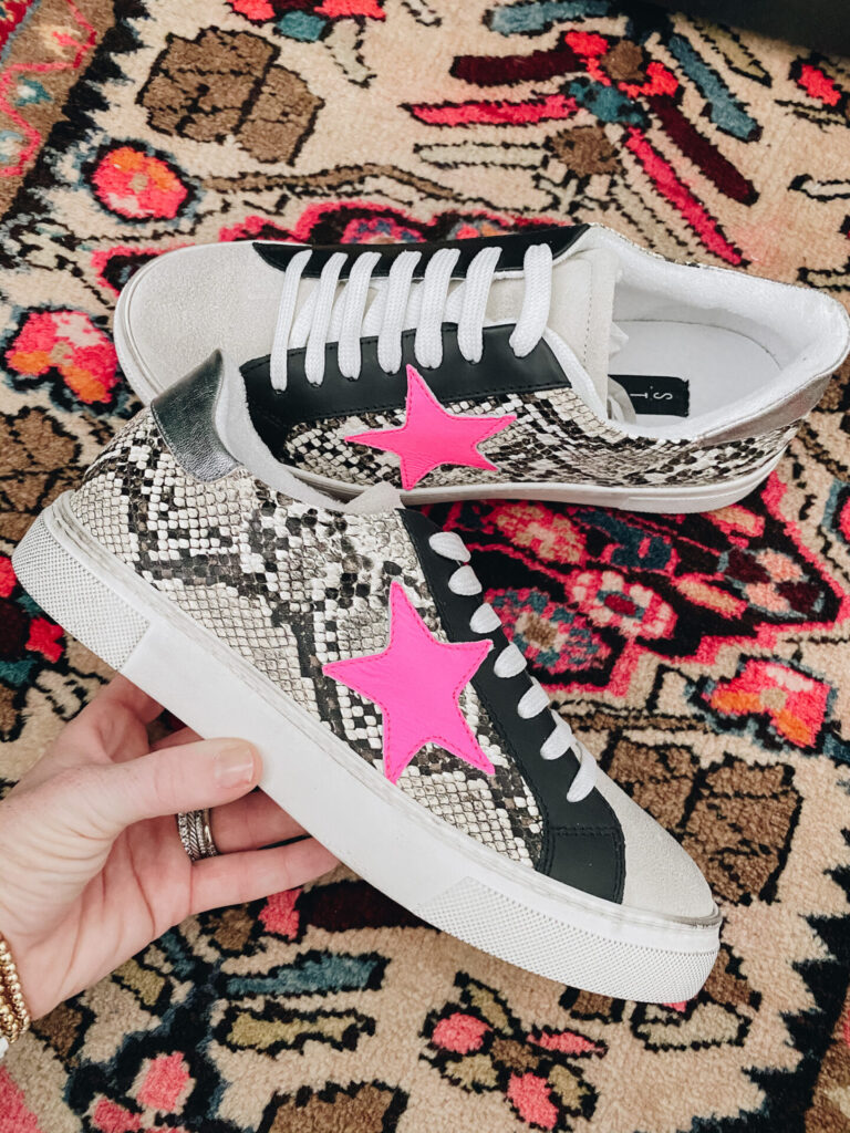 Independence Day Deals by popular Nashville life and style blog, Hello Happiness: image of Natasha Stoneking holding a pair of Steve Madden Ruby sneakers. 