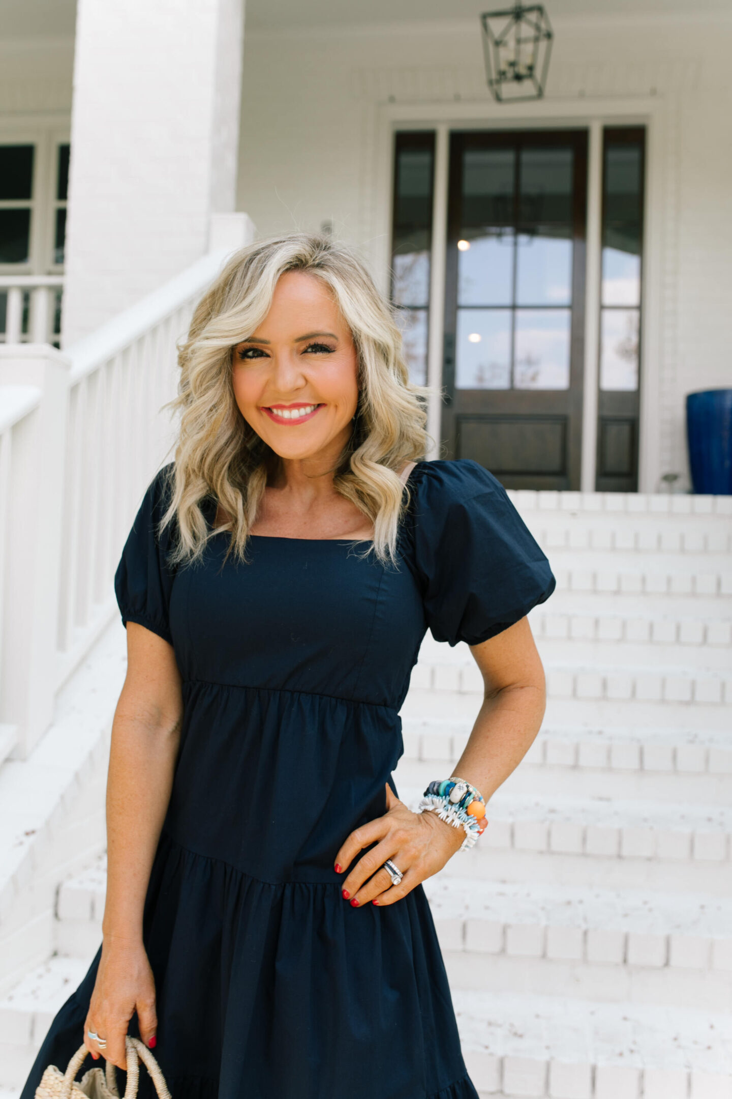 New Dress by popular Nashville lifestyle blog, Hello Happiness: image of a woman wearing a puff sleeve dress cake by the ocean bracelet, California girls bracelet, Hadley bracelet, after hours sunnies, pearl sandals, and holding a small loulou bag. 