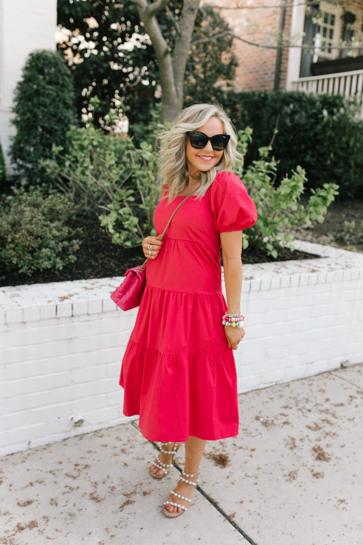 New Dress by popular Nashville lifestyle blog, Hello Happiness: image of a woman wearing a puff sleeve dress cake by the ocean bracelet, California girls bracelet, Hadley bracelet, after hours sunnies, pearl sandals, and holding a small loulou bag. 
