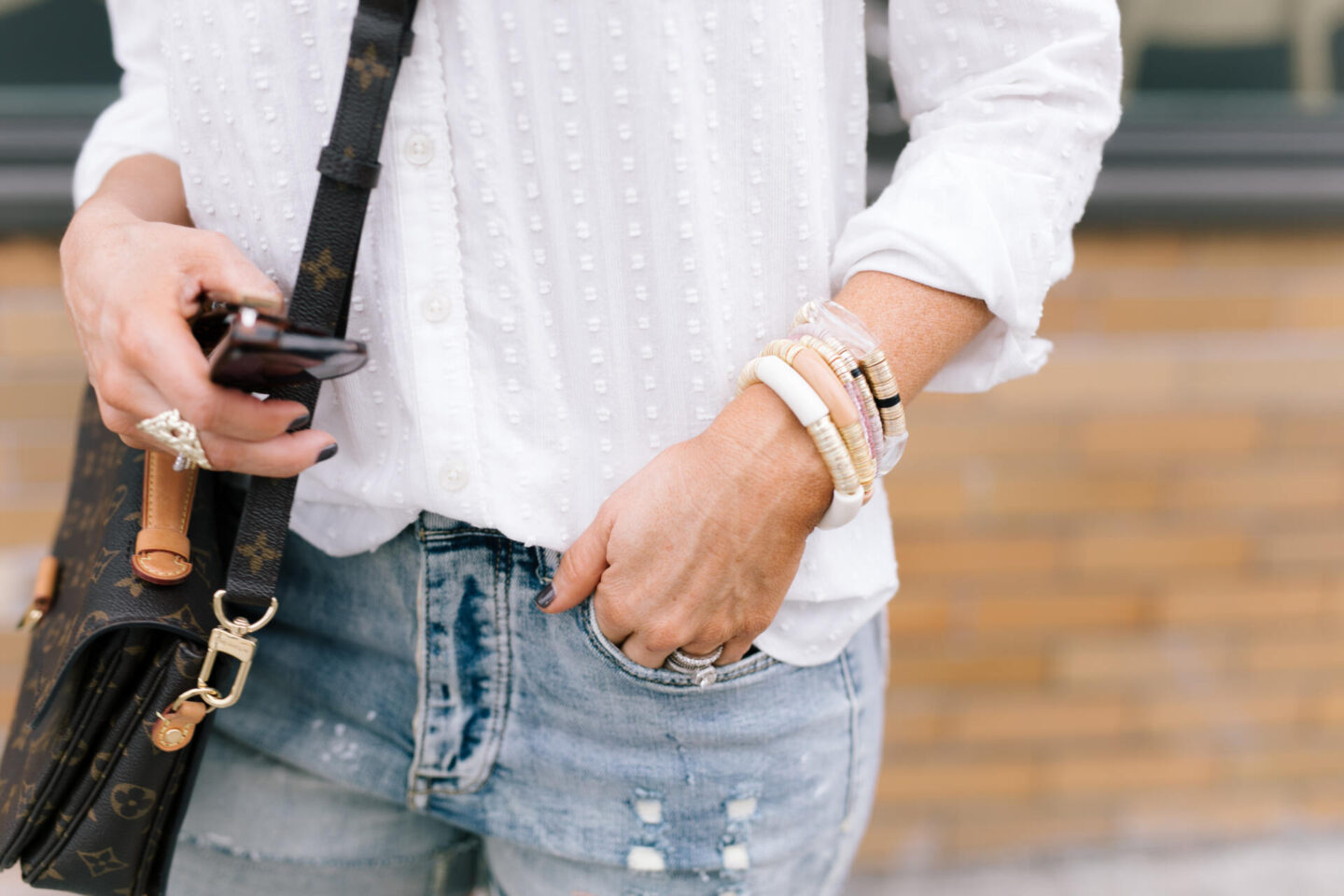 Anthro x Pilcro by popular Nashville fashion blog, Hello Happiness: image of Natasha Stoneking wearing some Anthro x Pilcro denim shorts, long sleeve white top, knot headband and carrying a Louis Vuitton purse. 
