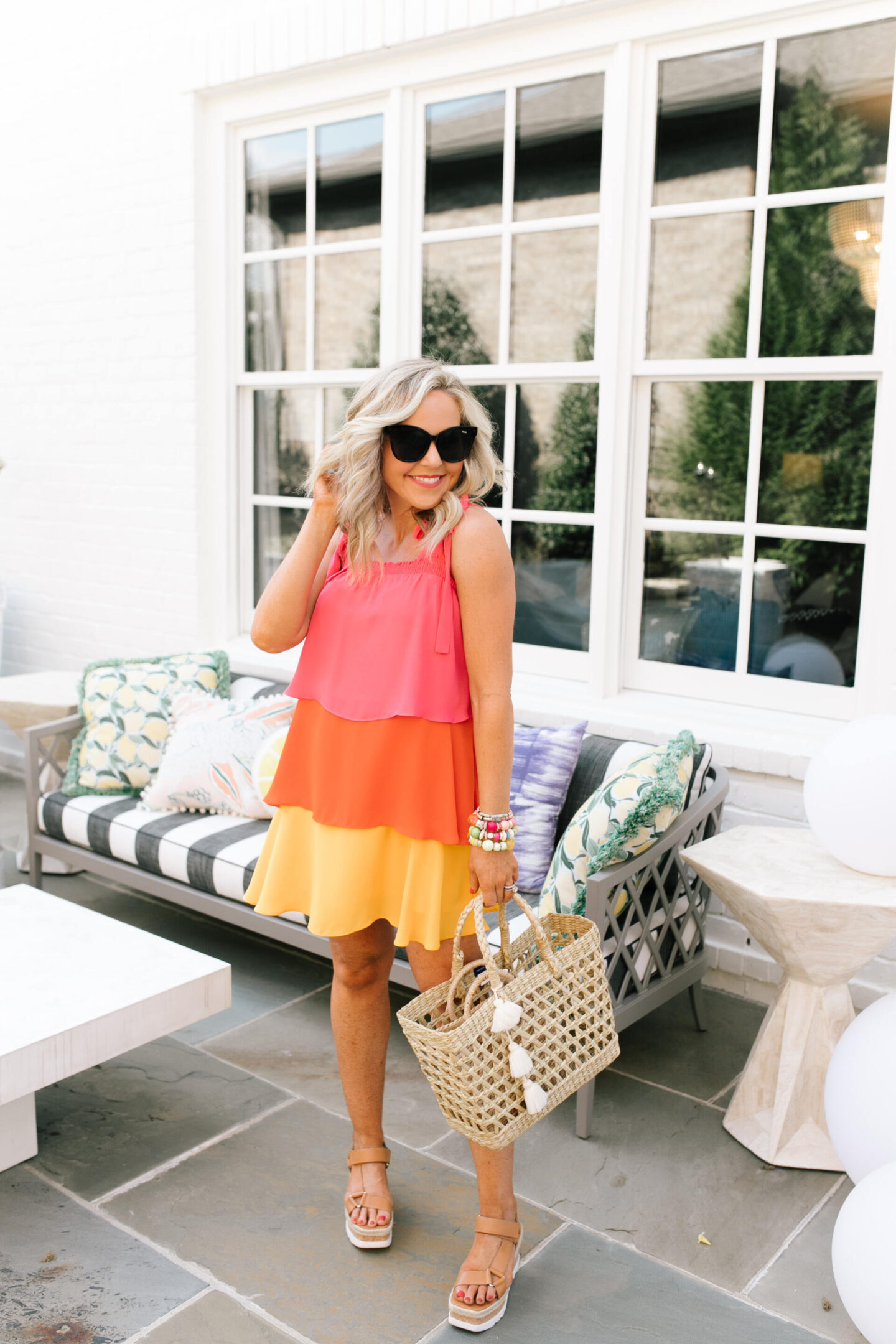 Summer Dresses by popular Nashville of Natasha Stoneking wearing a Sugarlips Colorblock Tiered dress and camel color strap platform wedge sandals. 