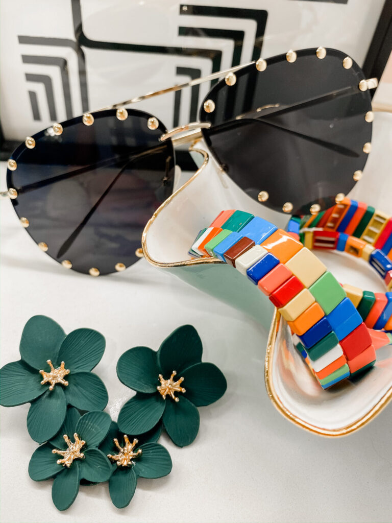 Amazon Favorites by popular Nashville life and style blog, Hello Happiness: image of a pair of Rimless Riveted Aviator Sunglasses, Olive Green Layered Floral Earrings, and Rainbow Tile Bracelet Set.