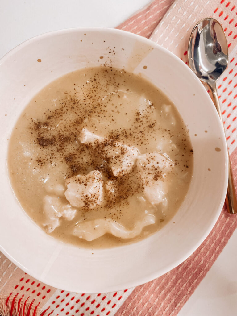 Chicken and Dumplings by popular Nashville lifestyle blog, Hello Happiness: image of a white ceramic bowl filled with chicken and dumplings. 