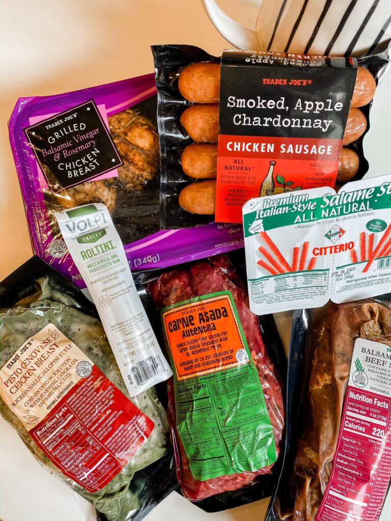 Trader Joe's Haul by popular Nashville lifestyle blog, Hello Happiness: image of Trader Joe's Smoked Apple Chardonnay chicken sausage, Trader Joe's Carne Asada, Trader Joe's Pesto Chicken Breast, and Trader Joe's Grilled chicken breast. 