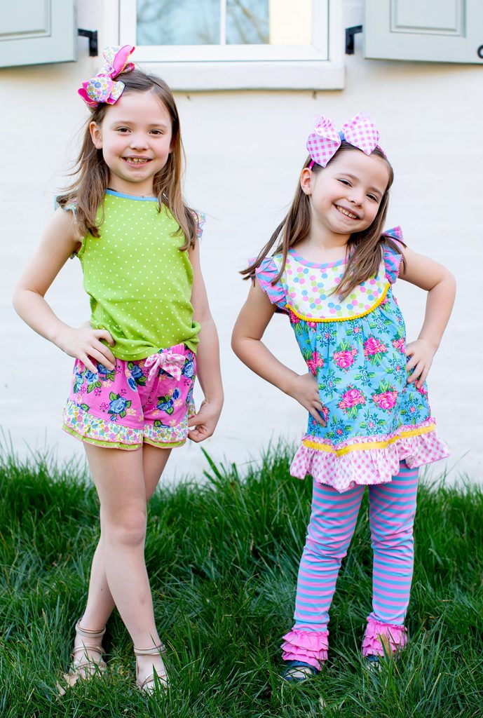 Ready, Set, SHOP! The Best in 4th of July Sales by popular Nashville fashion blog, Hello Happiness: image of two young girls standing outside wearing Matilda Jane Clothing Ditzy Daisy Tank, Matilda Jane Clothing Fresh Fantasy Tunic, and Matilda Jane Clothing La La Land Legging.