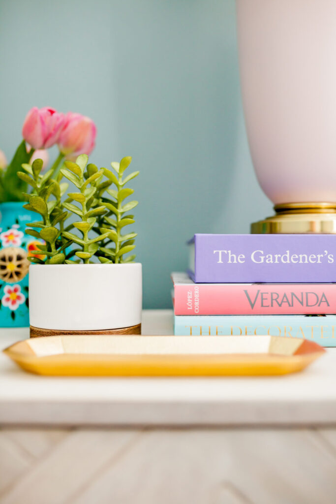 Coffee Table Books by popular Nashville lifestyle blog, Hello Happiness: image of a stack of coffee table books next to a succulent plant. 