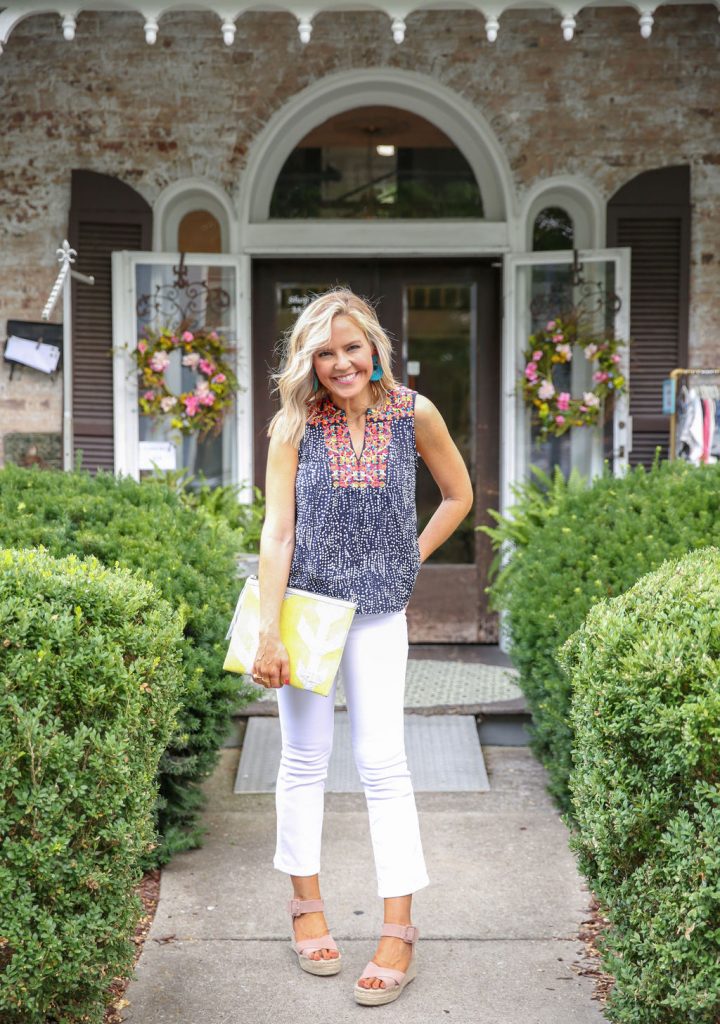 Summer Capsule Wardrobe featured by top US fashion blog Hello! Happiness; Image of a woman wearing Social Threads embroidered blouse and Blank NYC flare jeans.