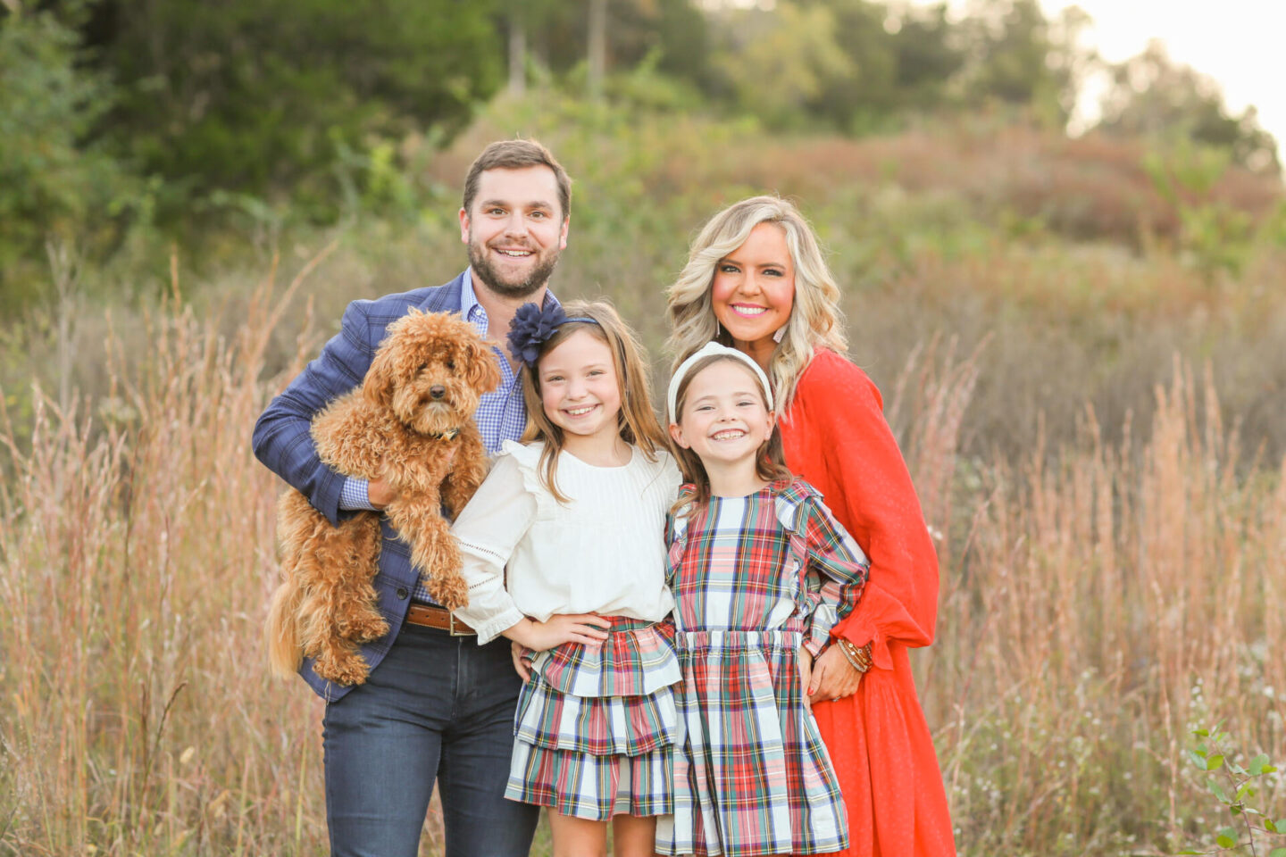 All About Me by popular Nashville lifestyle blog, Hello Happiness: image of a mom, dad, two daughter and a dog standing together in a field. 