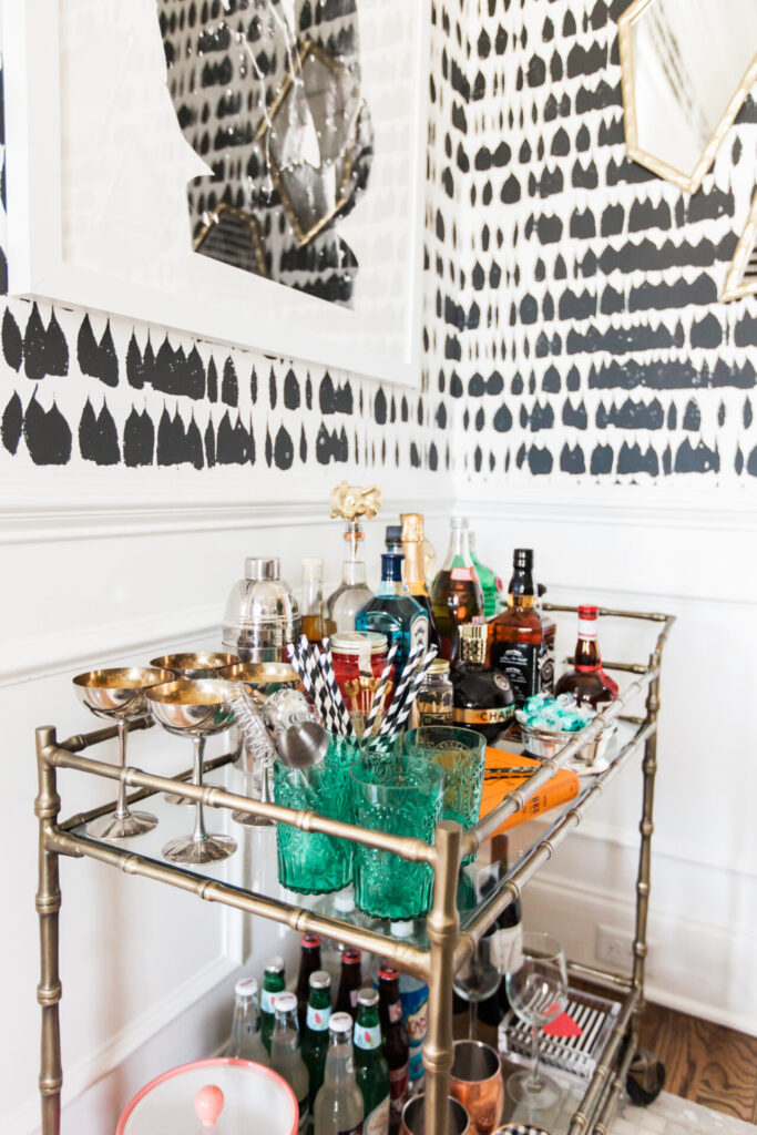 Bar Cart Essentials by popular Nashville lifestyle blog, Hello Happiness: image of a Ballard Designs Jill Bar Cart, framed Minted Moorten Cactus Study 1 print, Pottery Barn Harrison Bottle Coaster, Amazon The Essential Bar Book: An A-to-Z Guide to Spirits, Cocktails, and Wine, with 115 Recipes for the World's Great Drinks, and Schumacher QUEEN OF SPAIN wallpaper.