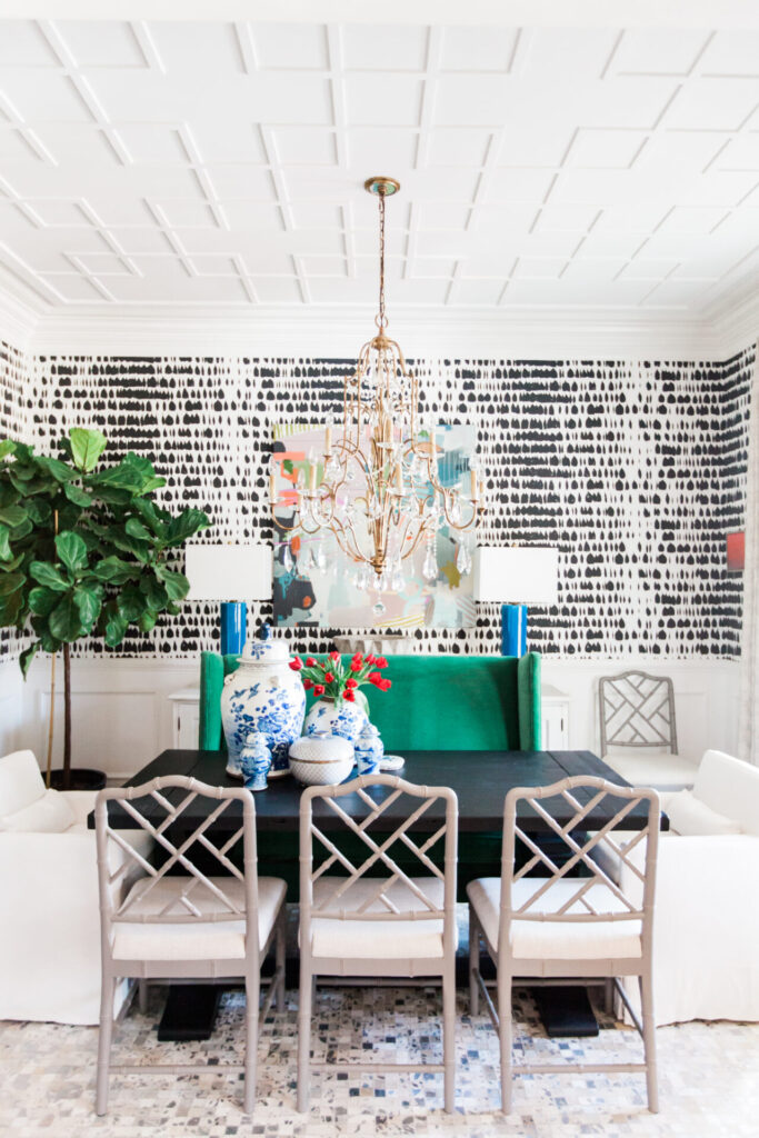 Ginger Jars by popular Nashville life and style blog, Hello Happiness: image of a black table with white chairs decorated with ginger jars and red tulips. 