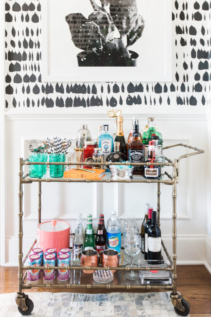 Bar Cart Essentials by popular Nashville lifestyle blog, Hello Happiness: image of a Ballard Designs Jill Bar Cart, framed Minted Moorten Cactus Study 1 print, Pottery Barn Harrison Bottle Coaster, Amazon The Essential Bar Book: An A-to-Z Guide to Spirits, Cocktails, and Wine, with 115 Recipes for the World's Great Drinks, and Schumacher QUEEN OF SPAIN wallpaper.