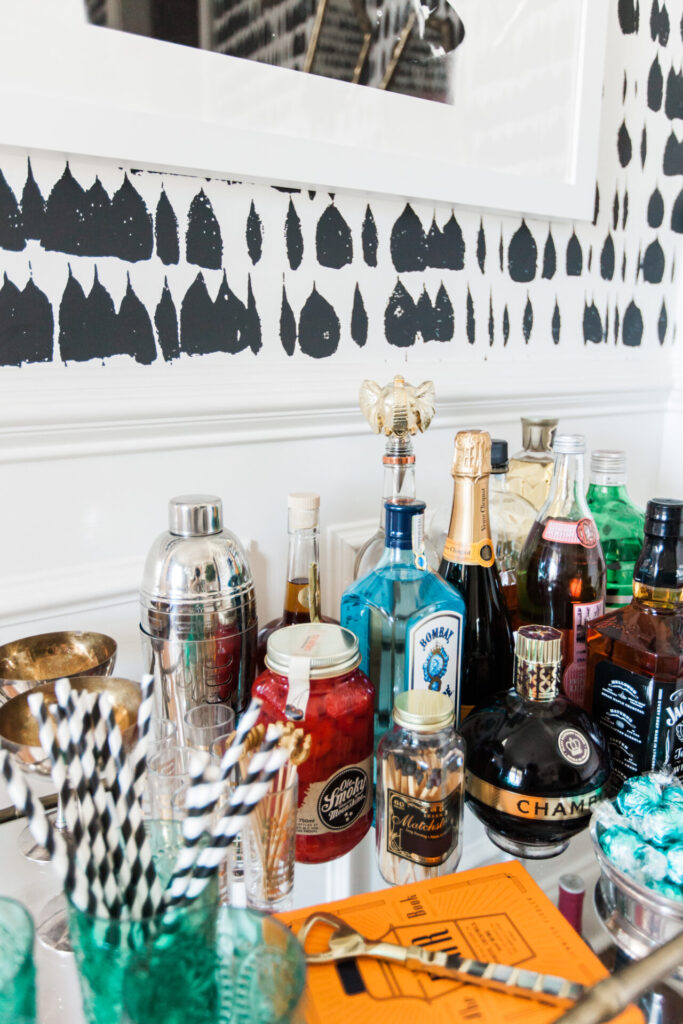 Bar Cart Essentials by popular Nashville lifestyle blog, Hello Happiness: image of a Ballard Designs Jill Bar Cart, framed Minted Moorten Cactus Study 1 print, Pottery Barn Harrison Bottle Coaster, Amazon The Essential Bar Book: An A-to-Z Guide to Spirits, Cocktails, and Wine, with 115 Recipes for the World's Great Drinks, and Schumacher QUEEN OF SPAIN wallpaper.